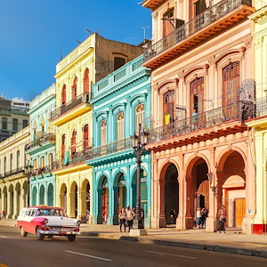 Colourful homes and classical cars against the blue sky in downtown Havana, Cuba