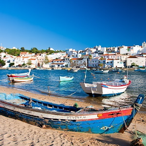 Ferragudo, Portugal - View of the village, sea and speedboats from the beach